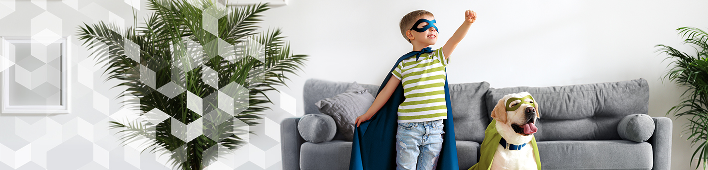 Boy and dog in superhero costumes in living room