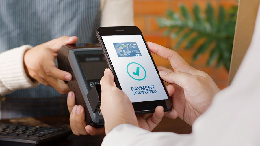 Hands using mobile payment on phone for kiosk purchase