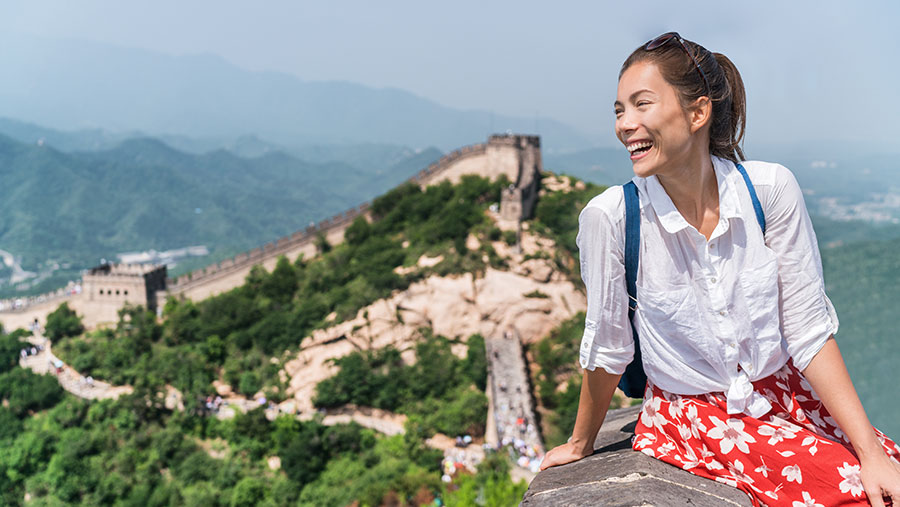 Woman sitting on the Great Wall of China
