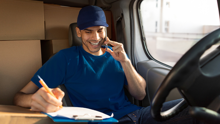 Man on phone in van with boxes