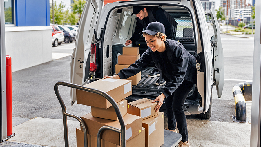 Man and Woman loading boxes into van