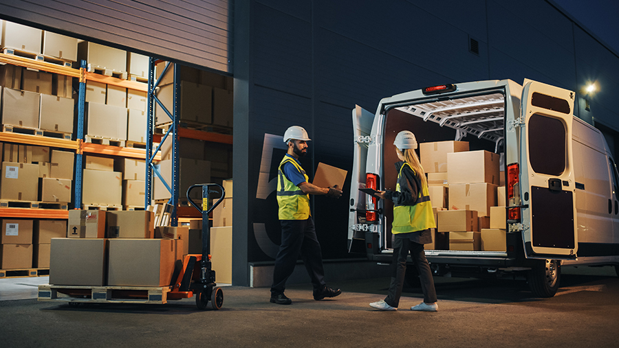Man and woman with boxes near warehouse