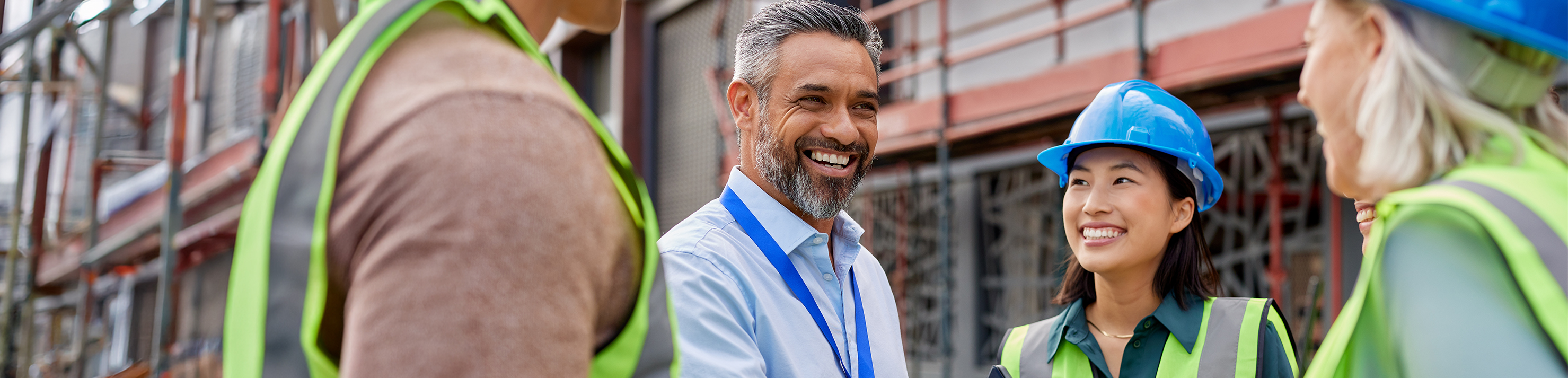 People in vests smiling at a man wearing a badge