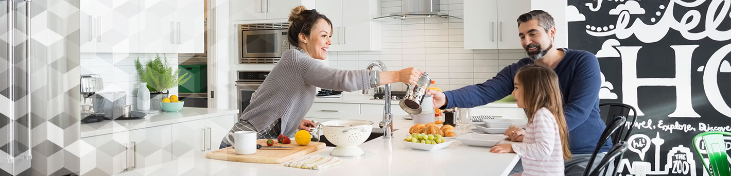 Family eating breakfast in kitchen.