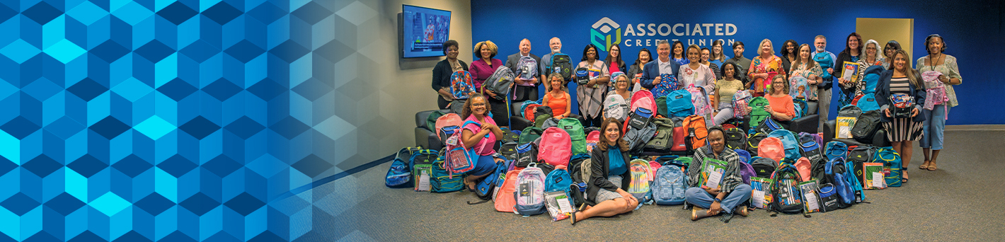 Main Office Group Photo of Employees with School Supplies and Backpacks