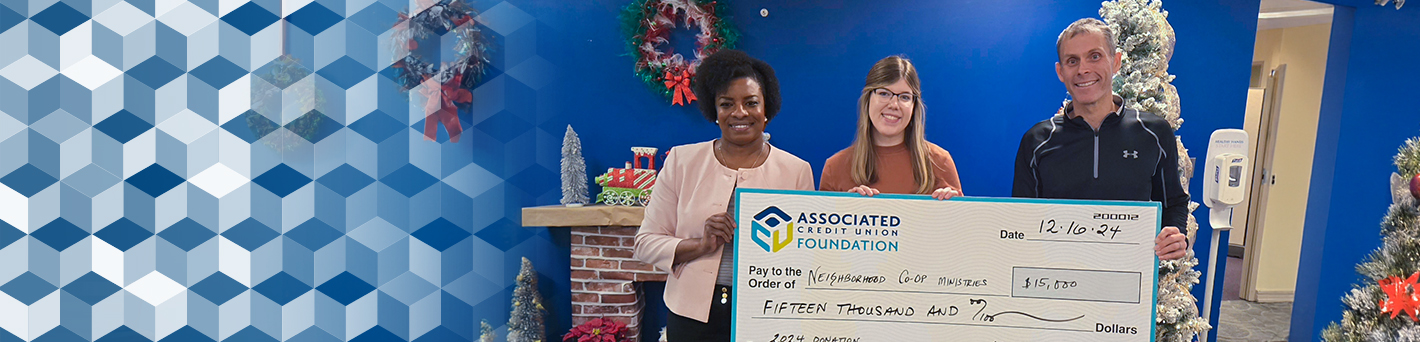 Group photo of employees presenting a large check